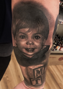 realistic Black and Gray Child Portrait Tattoo done by Cesar Perez form creative ink tattoos in Keene NH 